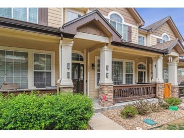 Inviting front porch with stone accents and manicured landscaping creates a warm welcome at 1466 Turnberry Dr, Castle Rock, CO 80104