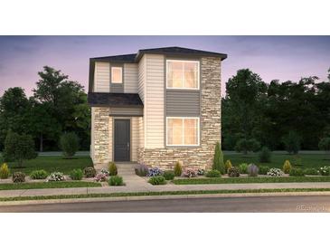 Two-story home with stone accents, neutral siding, manicured landscaping and a cozy front entry at 21166 E 62Nd Dr, Aurora, CO 80019