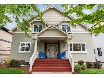 Charming home with a welcoming front porch, complete with red stairs, and blue chairs at 1526 S Gaylord St, Denver, CO 80210