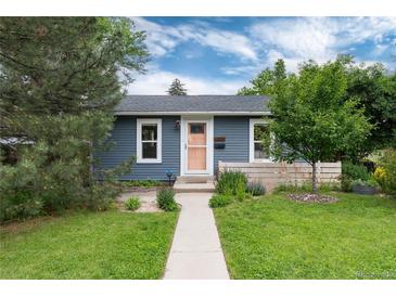 Charming blue single-story home with well-maintained lawn, walkway, and inviting, peach-colored front door at 3175 S Pennsylvania St, Englewood, CO 80113