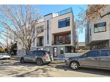 Modern townhome featuring a sleek design with balconies and a rooftop terrace on a sunny day at 3814 Zenobia St, Denver, CO 80212