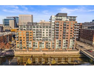 Multi-story condominium building featuring balconies overlooking the river with city views at 1401 Wewatta St # 911, Denver, CO 80202