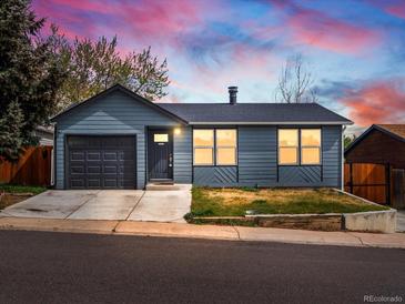 Charming single-story home with gray siding, attached garage, and well-manicured lawn on a well-lit street at 2433 E 90Th Ave, Thornton, CO 80229