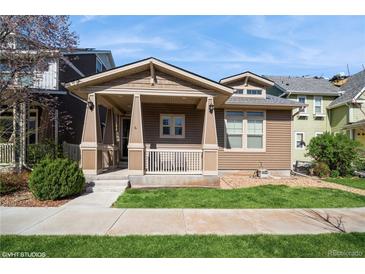Charming single-Gathering home featuring a cozy front porch and manicured lawn in a friendly neighborhood at 9675 E 105Th Ave, Commerce City, CO 80640