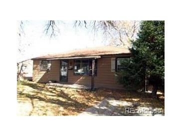 Ranch style home with mature trees and a well-maintained lawn at 1078 Elmira St, Aurora, CO 80010