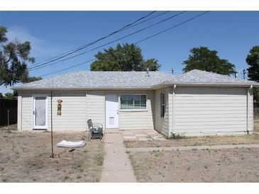 Charming single-story home featuring a well-maintained exterior and neutral-colored siding at 933 Skeel St, Brighton, CO 80601