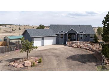 Stunning single-Gathering home boasts an attached three-car garage and well-maintained lawn at 5910 Mccart Ranch Cir, Elizabeth, CO 80107