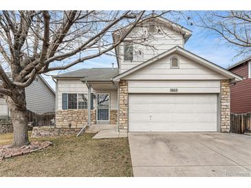 Charming two-story home featuring stone accents, a two-car garage, and a well-maintained front yard at 1663 W 135Th Way, Denver, CO 80234