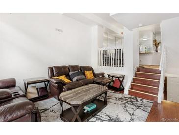 Inviting living room features a comfortable brown sofa, stylish coffee table, and sleek modern decor accents at 1885 S Quebec Way # G104, Denver, CO 80231