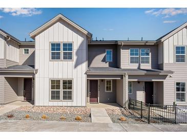 Beautiful townhome showcasing modern architecture and professional landscaping at 16794 W 94Th Way, Arvada, CO 80007