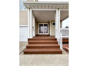 Inviting front porch with well-maintained wooden steps leading to a charming entrance at 20308 E 48Th Dr, Denver, CO 80249