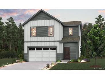 Charming two-story home with a two-car garage, professionally landscaped front yard and modern architecture at 19038 E 94Th Pl, Commerce City, CO 80022