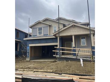 New construction with a front-facing two car garage, craftsman columns, and shingle siding at 7337 S Yank Ct, Littleton, CO 80127