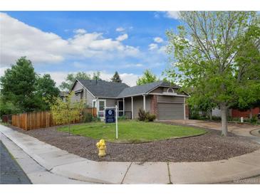 Charming single Gathering home with a well maintained lawn, mature trees, and a two car garage at 3844 S Gibralter St, Aurora, CO 80013
