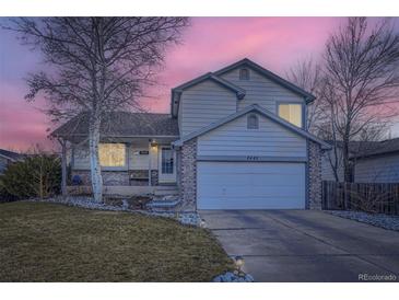 Charming two-story home featuring a two car garage, stone accents and beautifully landscaped front yard at 2482 Purcell Pl, Brighton, CO 80601