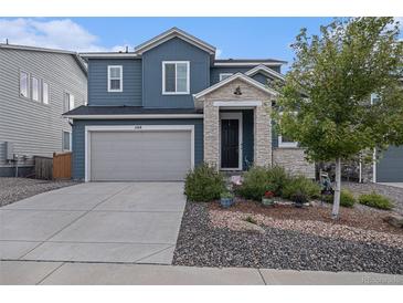 Charming two-story home with a two car garage, landscaped yard, and stone porch at 1168 Basalt Ridge Loop, Castle Rock, CO 80108