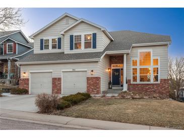 Charming two-story home boasts a two-car garage, brick accents, and inviting curb appeal in a desirable neighborhood at 781 Deer Clover Cir, Castle Pines, CO 80108