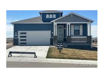 Charming home with a two-car garage, lovely front porch, and inviting curb appeal at 42996 Colonial Trl, Elizabeth, CO 80107