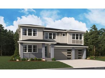 Two story home with gray siding, two car garage, and landscaping at 8686 Pennycress Dr, Littleton, CO 80125