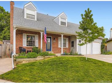 Charming brick home with a welcoming front porch, dormer windows, and a well-maintained lawn at 5456 E Briarwood Pl, Centennial, CO 80122
