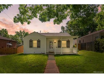 Charming single-story home with a well-manicured lawn and inviting front porch at 740 Cherry St, Denver, CO 80220