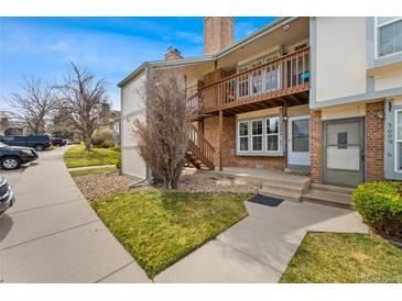 Charming multi-level home showcasing a well-kept lawn and cozy upper balcony at 3090 W 107Th Pl # F, Westminster, CO 80031