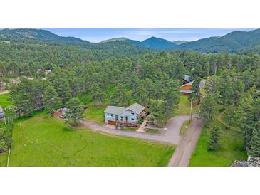 Aerial view of the home nestled in a serene wooded area at 4724 Hopi Rd, Indian Hills, CO 80454