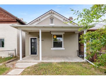 Charming bungalow featuring a covered front porch and neutral exterior paint scheme at 2841 Stout St, Denver, CO 80205