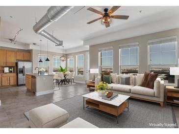 Open living room and kitchen with city views at 10111 Inverness Main St # 331, Englewood, CO 80112