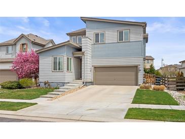 Charming two-story home with modern design, landscaped yard, and a two-car garage at 11048 Rifle Ct, Commerce City, CO 80022
