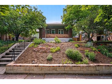 Charming brick home with terraced front yard, lush greenery, and inviting curb appeal at 3321 Stuart St, Denver, CO 80212