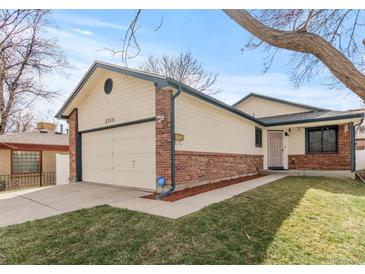 Charming home featuring a well-manicured lawn, two-car garage and traditional brick accents at 3355 S Emerson St, Englewood, CO 80113