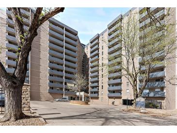 Exterior view of a modern high rise apartment building with balconies and a circular driveway at 601 W 11Th Ave # 815, Denver, CO 80204