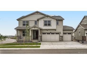 Charming two-story home with a two car garage and landscaped front yard at 98 Wooten Ave, Brighton, CO 80601