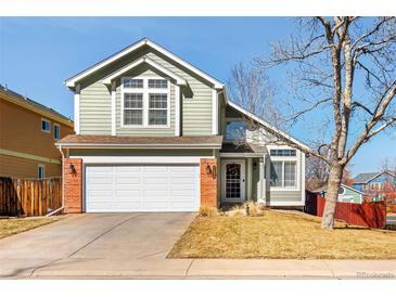 Charming two-story home with a two-car garage, landscaped yard, and a welcoming front entrance at 7255 W 97Th Pl, Broomfield, CO 80021