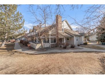 Charming home featuring mature trees and a covered porch, perfect for relaxing outdoors at 1132 E 130Th Ave # A, Thornton, CO 80241