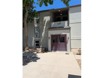Exterior view of the apartment building entrance with dual doors and a welcoming facade at 7346 S Xenia Cir # A, Centennial, CO 80112