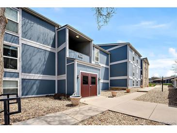 Attractive blue and white two-story home featuring landscaped yard and walkway to the front door at 7346 S Xenia Cir # A, Centennial, CO 80112