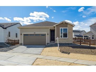 Charming single-story home featuring a two-car garage, landscaped yard, and a welcoming front entrance at 1300 Sienna Peak Cir, Erie, CO 80516