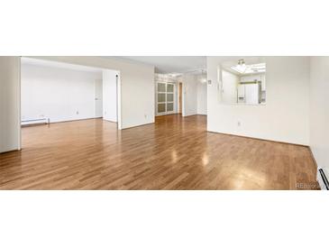 Spacious living room featuring hardwood floors and an open layout, perfect for entertaining and relaxation at 13601 E Marina Dr # 604, Aurora, CO 80014