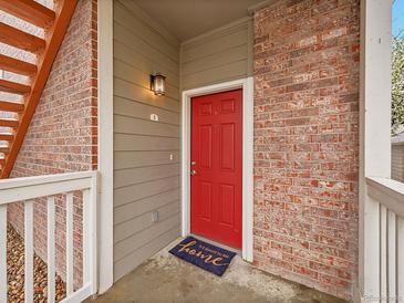Inviting front door with brick surround and covered porch entry at 16366 E Fremont Ave # 3, Aurora, CO 80016