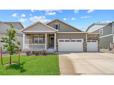 Charming single-Gathering home with a two-car garage, stone accents, a welcoming porch, and a manicured front lawn at 3197 Belleville Ridge Rd, Elizabeth, CO 80107