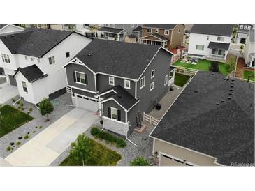 A stunning aerial view showcases this home's well-manicured lawn and desirable neighborhood setting at 2637 Gray Wolf Pl, Castle Rock, CO 80104
