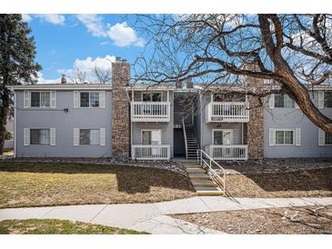 Inviting condo exterior featuring balconies, stone accents, and well-maintained landscaping for a charming curb appeal at 13241 E Asbury Dr # 203, Aurora, CO 80014
