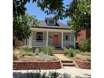 Charming home featuring a cozy front porch and a well-maintained, landscaped front yard at 613 S Logan St, Denver, CO 80209