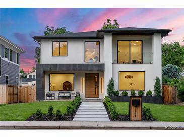 Stunning two-story modern home with a manicured lawn, sleek walkway, and stylish architectural details at 1518 S Columbine St, Denver, CO 80210