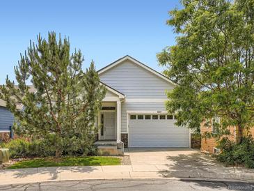 Charming single-Gathering home with a two-car garage, light-blue siding, and well-maintained landscaping at 625 Kendall Way, Lakewood, CO 80214