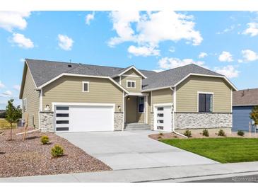 Charming one-story home with attached two car garage, stone accents, and a well-manicured lawn at 42979 Colonial Trl, Elizabeth, CO 80107