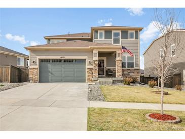 Charming two-story home with a well-maintained front yard and a welcoming entrance, including a two car garage at 18189 House Finch Ln, Parker, CO 80134