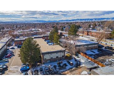 Aerial view of a multi-unit building with ample parking and mountain views at 4653 S Lowell Blvd # B, Denver, CO 80236
